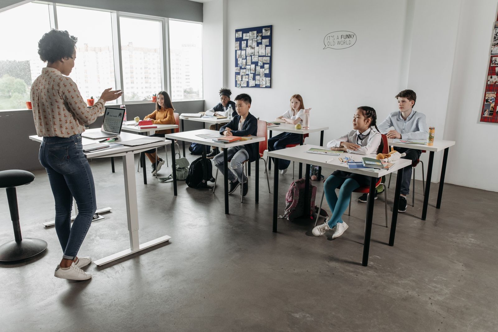 A teacher teaching engaged students in a bright classroom